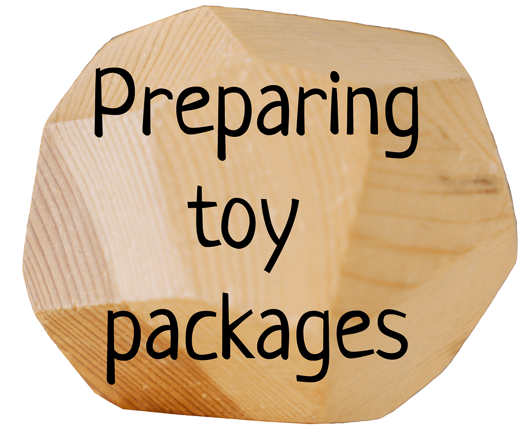 Wooden block with text 'Preparing toy packages'